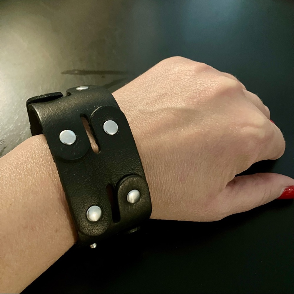 Black leather snap bracelet.